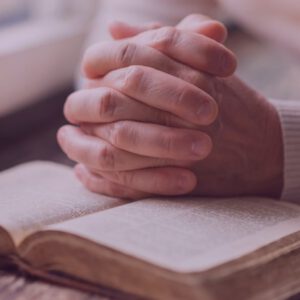 SLI-planned-gift Hands praying on book filtered