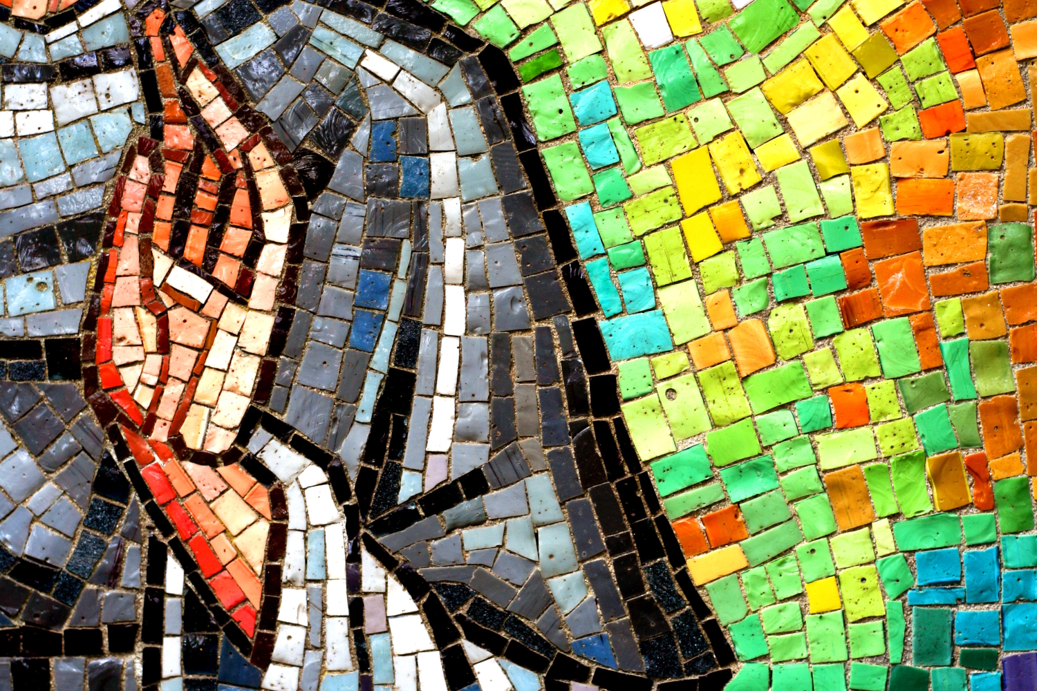 Part of a stained glass image showing a mosaic of a hand giving a blessing