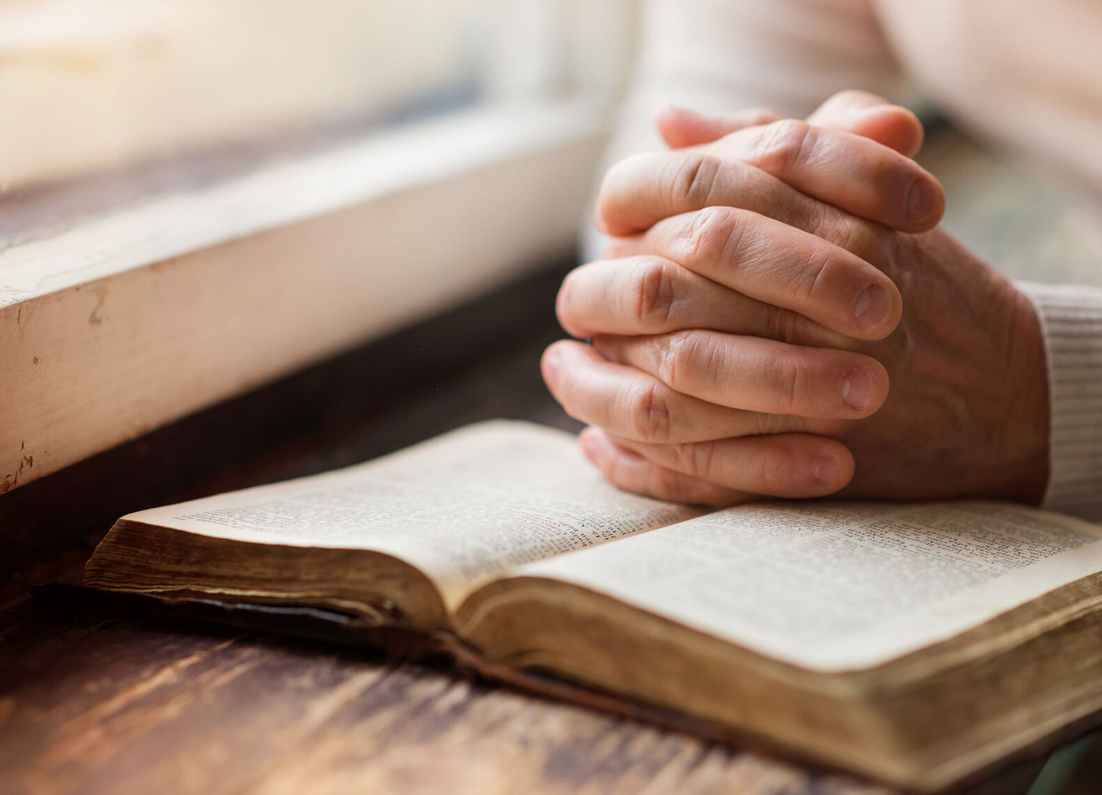 reading-praying-bible-older-hands