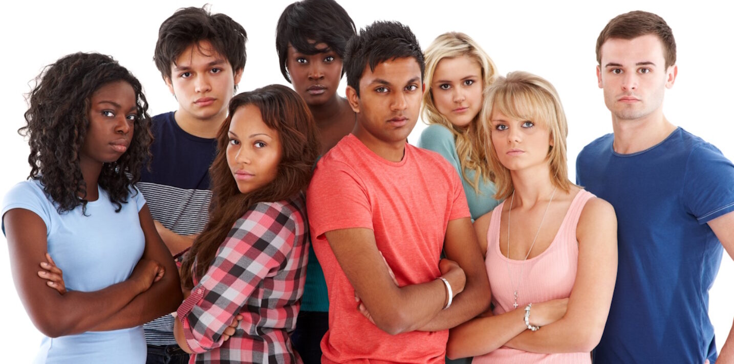 Portrait of diverse group of college students standing together on white background