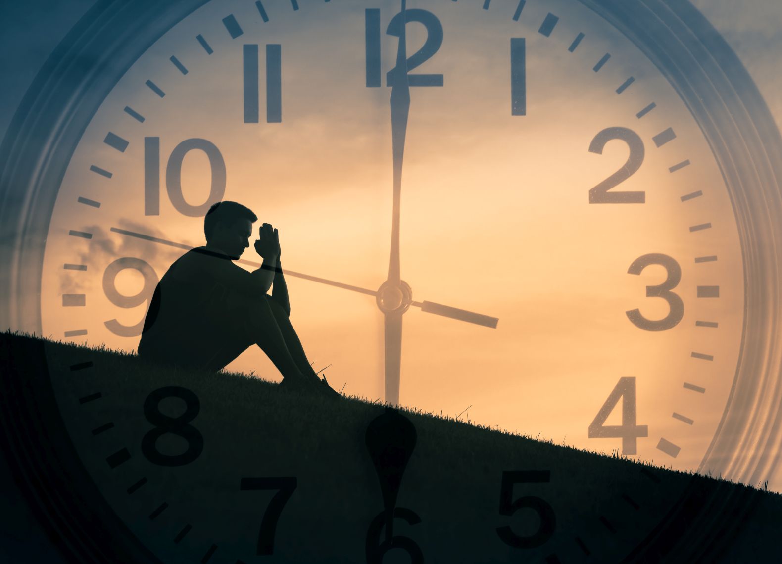 Double exposure of young man praying outdoors with clock in the background.