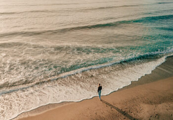 Lonely woman standing on the beach